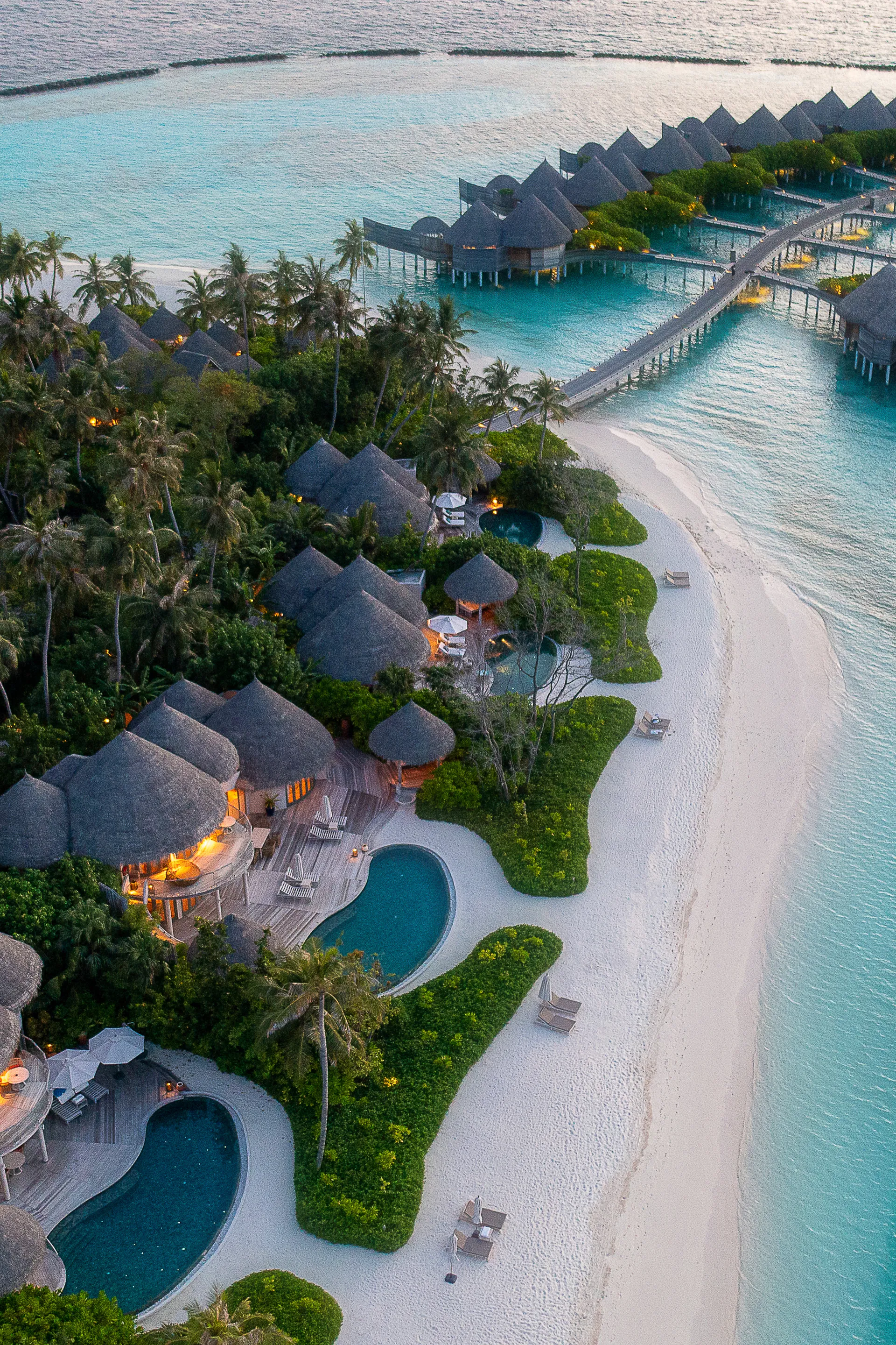Overwater villas at dusk seen from the air