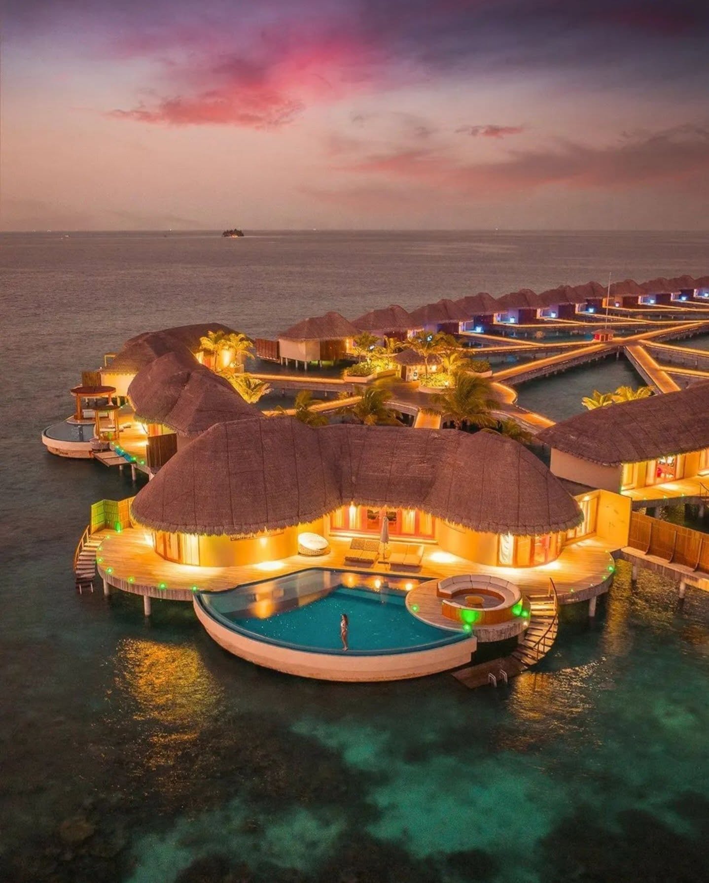 Overwater villas glowing at sunset